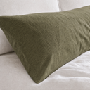 Moss green linen euro sham close-up showing textured French flax fabric and neat stitching