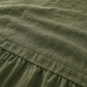 Close-up moss green French flax linen weave and gathered elastic hem detail
