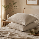 Oat linen pillowcase set styled on bed with olive branches