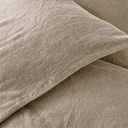Close-up of washed French flax linen texture and stitching