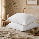 White washed linen pillowcases layered on beige bedding for bedroom decor